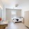 a bedroom with a bed sink and a mirror