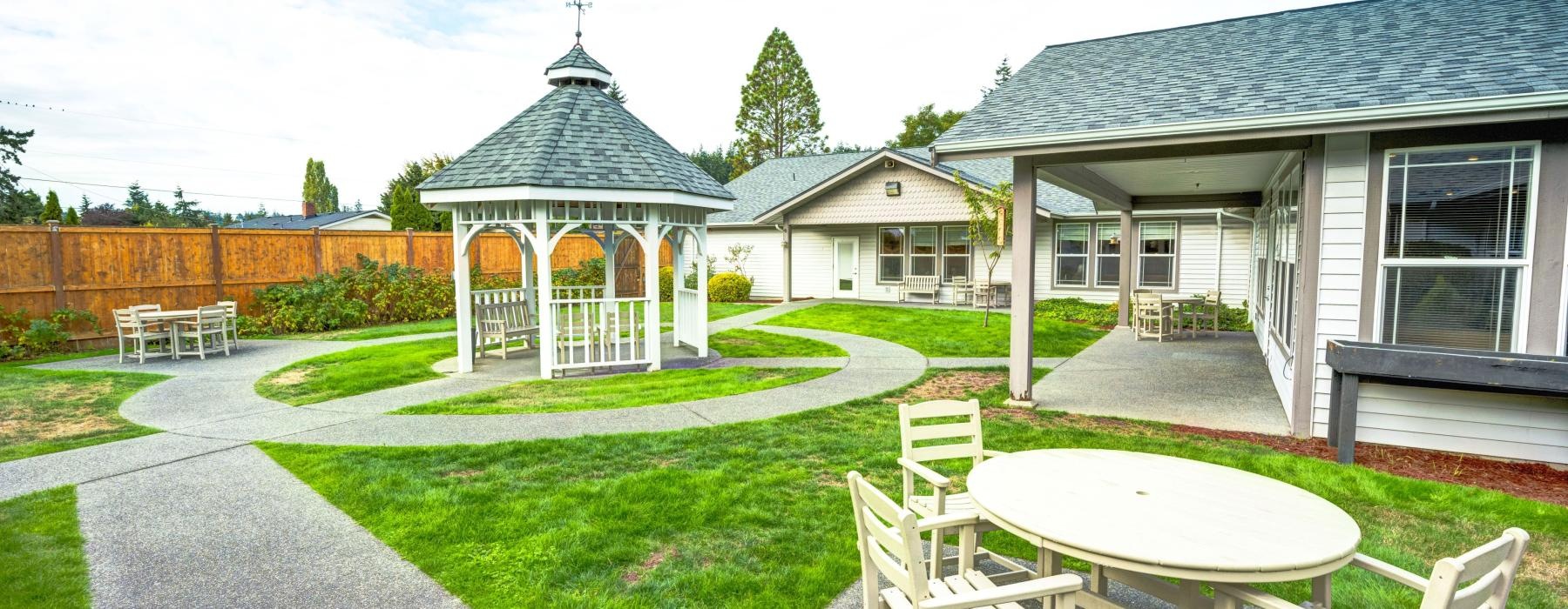 a backyard with a table and chairs