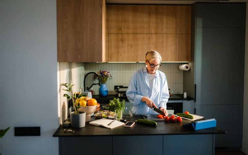 a woman cutting vegetables in the kitchen